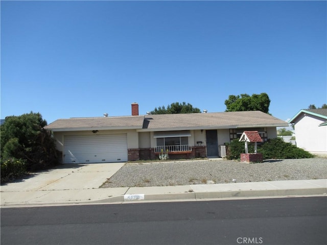 single story home featuring a garage, concrete driveway, and a chimney