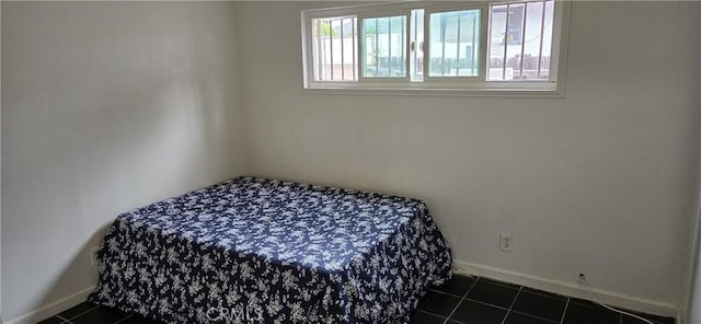 9715 La Docena Ln, Pico Rivera, CA 90660 - bedroom with baseboards and dark tile patterned floors
