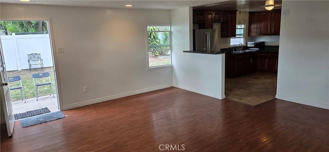 9715 La Docena Ln, Pico Rivera, CA 90660 - kitchen featuring freestanding refrigerator, dark wood-style flooring, dark countertops, plenty of natural light, and recessed lighting