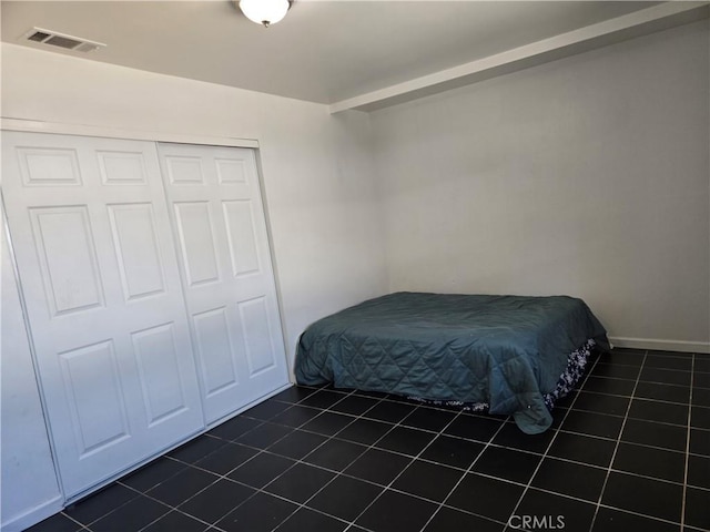 9715 La Docena Ln, Pico Rivera, CA 90660 - bedroom featuring dark tile patterned flooring and a closet