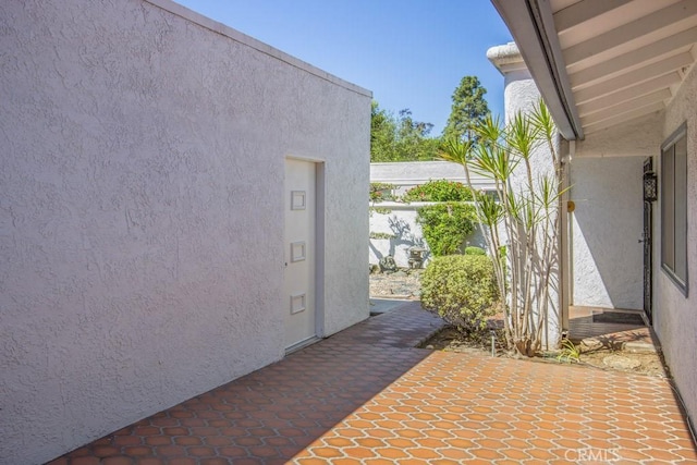 3424 Calle Azul Unit A, Laguna Woods, CA 92637 - view of home's exterior featuring stucco siding and a patio area
