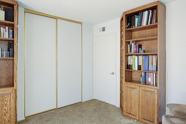 3424 Calle Azul Unit A, Laguna Woods, CA 92637 - carpeted bedroom featuring a closet and a textured ceiling