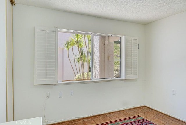 3424 Calle Azul Unit A, Laguna Woods, CA 92637 - unfurnished room featuring baseboards and a textured ceiling