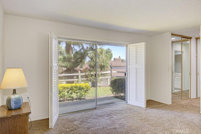 3424 Calle Azul Unit A, Laguna Woods, CA 92637 - doorway with carpet flooring, a textured ceiling, and baseboards