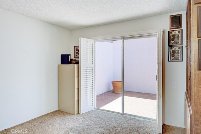 3424 Calle Azul Unit A, Laguna Woods, CA 92637 - unfurnished bedroom featuring carpet floors, a textured ceiling, and a closet