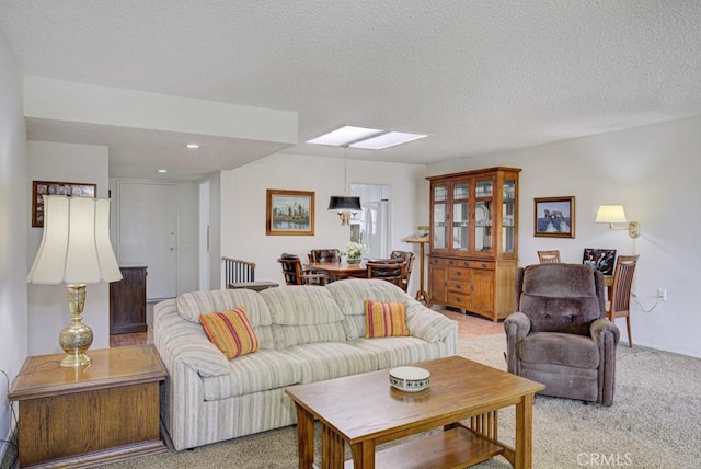 3424 Calle Azul Unit A, Laguna Woods, CA 92637 - living room with light colored carpet, a skylight, a textured ceiling, recessed lighting, and baseboards