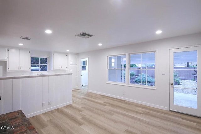 unfurnished living room with light wood-style flooring, recessed lighting, and baseboards