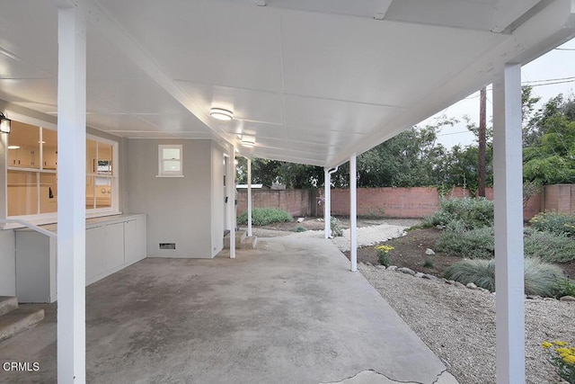 view of patio / terrace with a fenced backyard and an attached carport