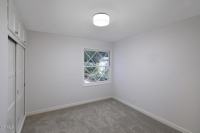 spare room with carpet flooring and baseboards