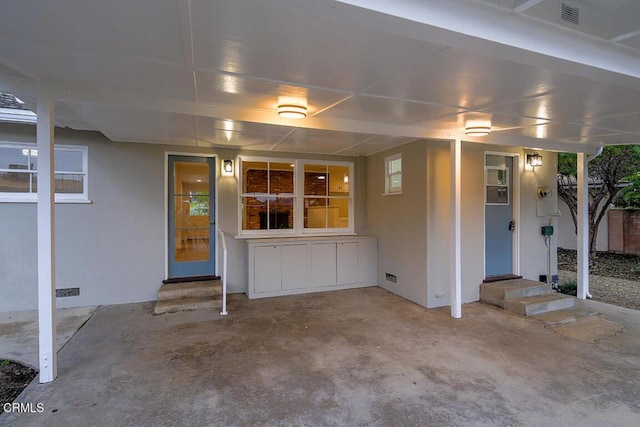 view of patio / terrace with entry steps and a carport