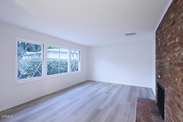 6429 Creemore Ln, Tujunga, CA 91042 - unfurnished room featuring a brick fireplace, wood finished floors, and baseboards