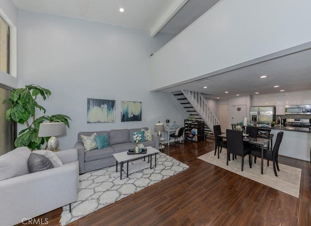 living area featuring stairway, dark wood-type flooring, and recessed lighting