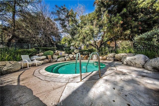 view of swimming pool with a fenced backyard and a patio