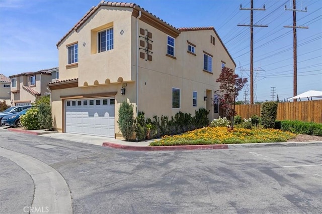 view of side of property featuring fence, stucco siding, and a tile roof