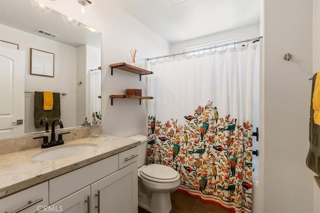 bathroom with toilet, vanity, tile patterned flooring, and curtained shower