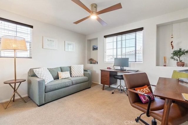office space with ceiling fan, healthy amount of natural light, and carpet floors