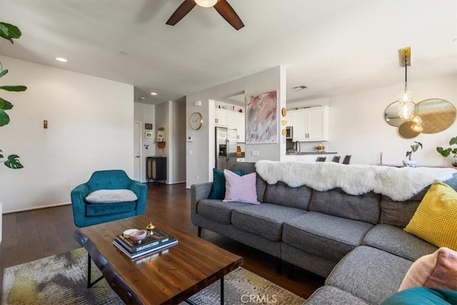 living area featuring ceiling fan, wood finished floors, and recessed lighting