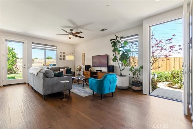 living room with hardwood / wood-style flooring and ceiling fan