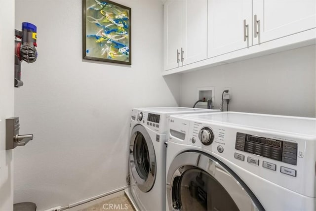 laundry area featuring cabinet space, washer and clothes dryer, and baseboards