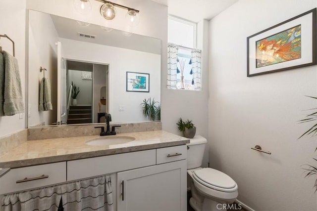 bathroom with vanity and toilet