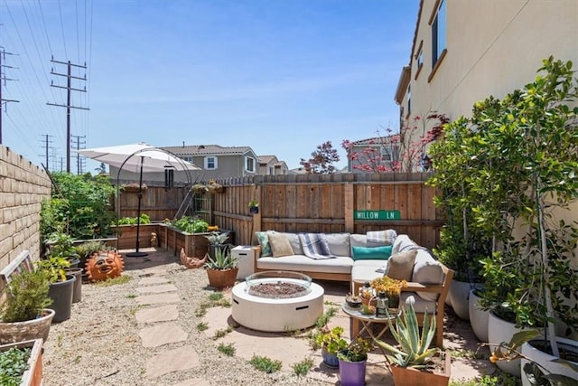 view of patio / terrace featuring a fenced backyard and a garden