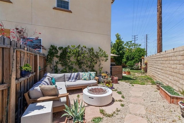 view of patio featuring an outdoor living space with a fire pit and a fenced backyard