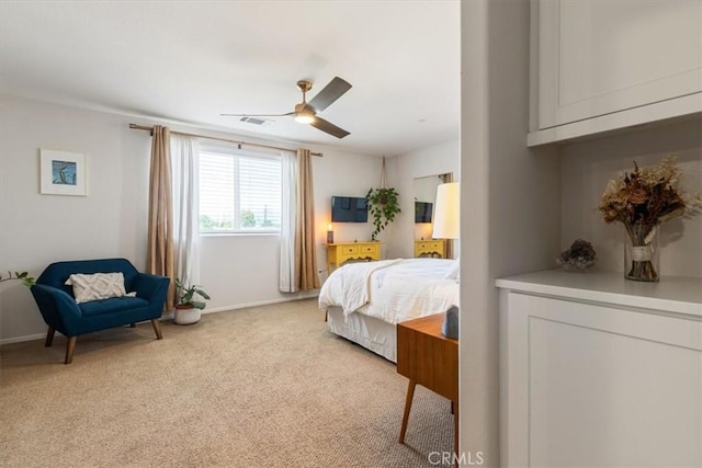 bedroom featuring light colored carpet, baseboards, and ceiling fan