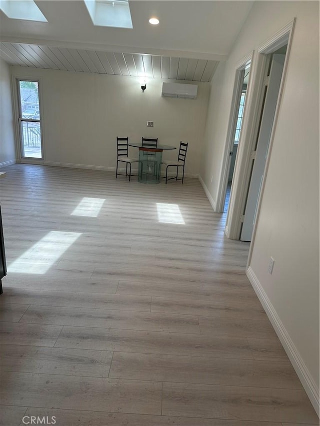 1322 S Walnut Ave, West Covina, CA 91790 - spare room featuring a skylight, light wood-style floors, baseboards, a wall mounted air conditioner, and recessed lighting