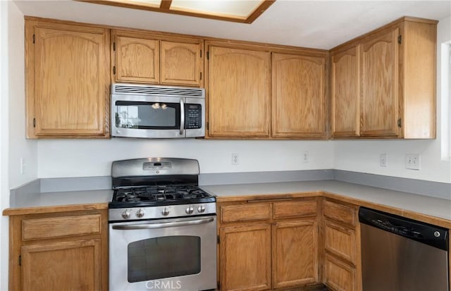 7728 Balsa Ave, Yucca Valley, CA 92284 - kitchen with appliances with stainless steel finishes and light countertops