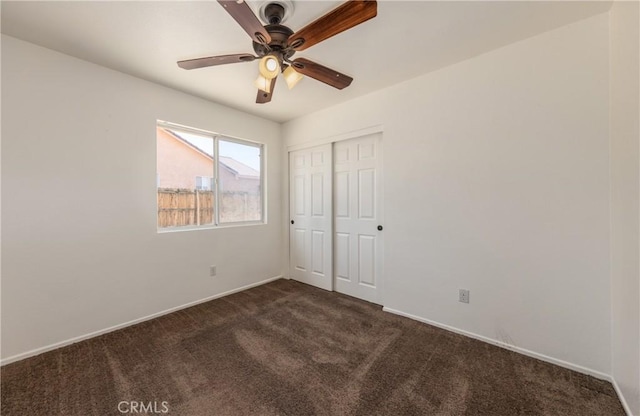 7728 Balsa Ave, Yucca Valley, CA 92284 - unfurnished bedroom with dark colored carpet, a closet, baseboards, and a ceiling fan