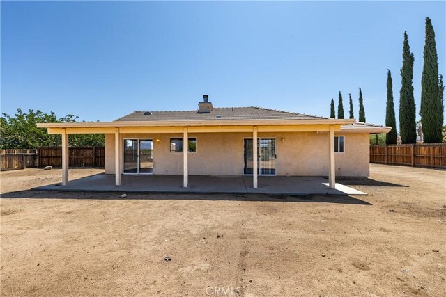 7728 Balsa Ave, Yucca Valley, CA 92284 - back of house with a patio, stucco siding, and a chimney