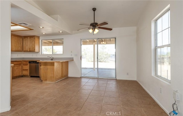 7728 Balsa Ave, Yucca Valley, CA 92284 - kitchen with stainless steel dishwasher, a ceiling fan, light countertops, a peninsula, and light tile patterned flooring