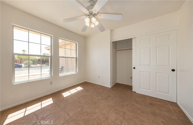 7728 Balsa Ave, Yucca Valley, CA 92284 - unfurnished bedroom with light tile patterned floors, baseboards, a closet, and ceiling fan