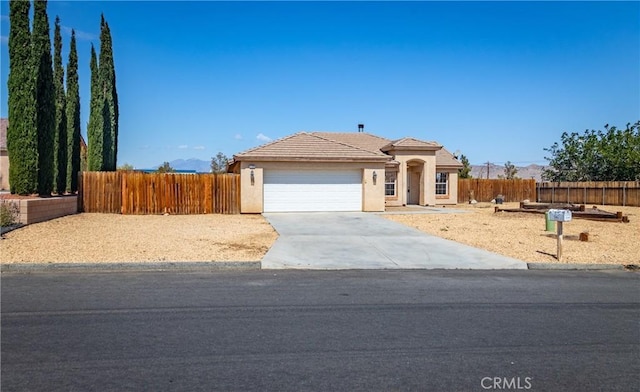 7728 Balsa Ave, Yucca Valley, CA 92284 - view of front of house featuring stucco siding, a garage, driveway, and a tiled roof