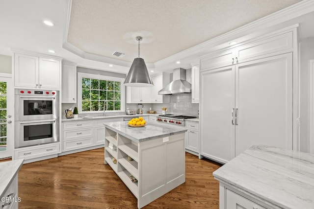 kitchen with wall chimney range hood, appliances with stainless steel finishes, open shelves, white cabinetry, and recessed lighting