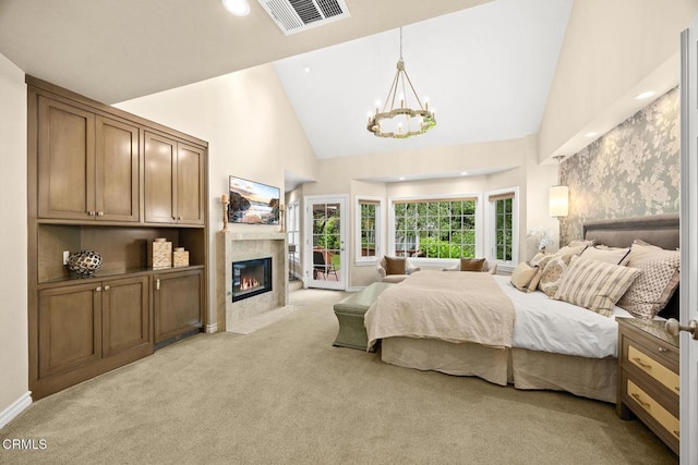 bedroom featuring light colored carpet, a chandelier, high vaulted ceiling, a high end fireplace, and access to outside