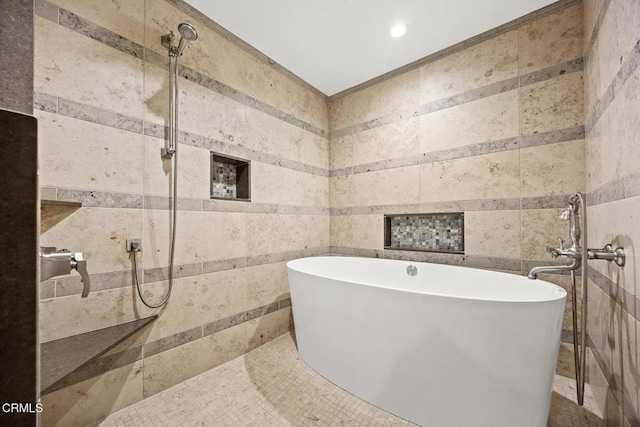 full bath featuring tile walls, a soaking tub, and recessed lighting
