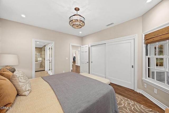 bedroom featuring wood finished floors, recessed lighting, a closet, baseboards, and ensuite bathroom
