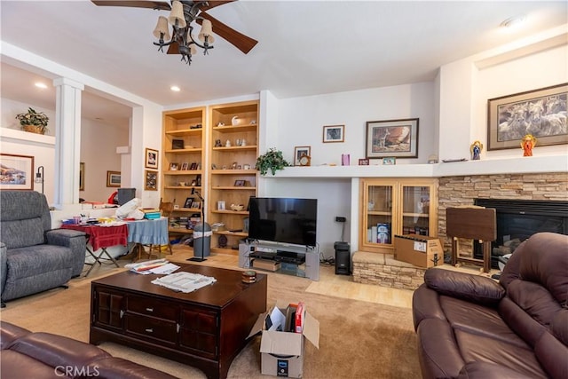 33220 Wilson St, Wildomar, CA 92595 - living room featuring a ceiling fan, a stone fireplace, recessed lighting, carpet floors, and built in shelves