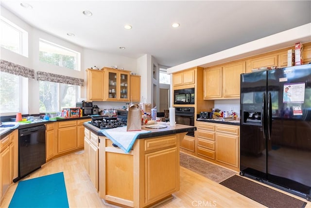 33220 Wilson St, Wildomar, CA 92595 - kitchen featuring black appliances, light brown cabinetry, a center island, light wood finished floors, and glass insert cabinets