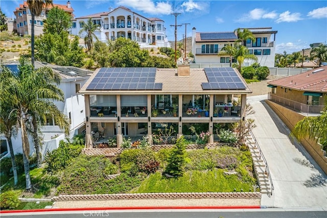 22299 San Joaquin Dr W, Canyon Lake, CA 92587 - rear view of house featuring roof mounted solar panels, a balcony, and stucco siding