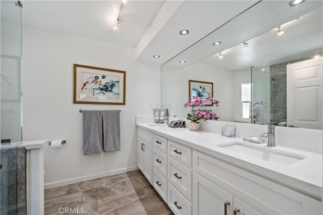 22299 San Joaquin Dr W, Canyon Lake, CA 92587 - full bathroom featuring rail lighting, a shower stall, baseboards, double vanity, and recessed lighting