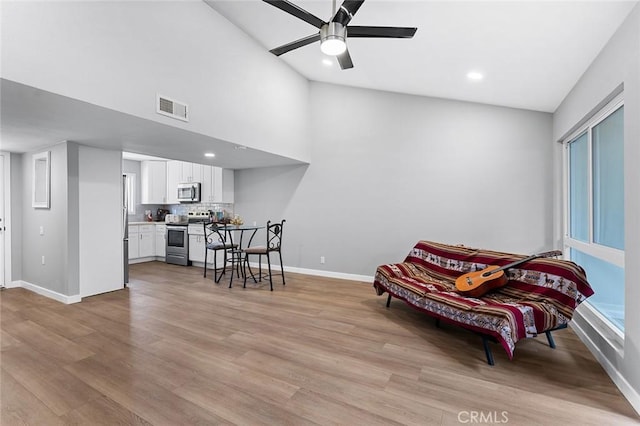 3660 Vista Campana N Unit 11, Oceanside, CA 92057 - living area with baseboards, a ceiling fan, light wood-type flooring, recessed lighting, and high vaulted ceiling
