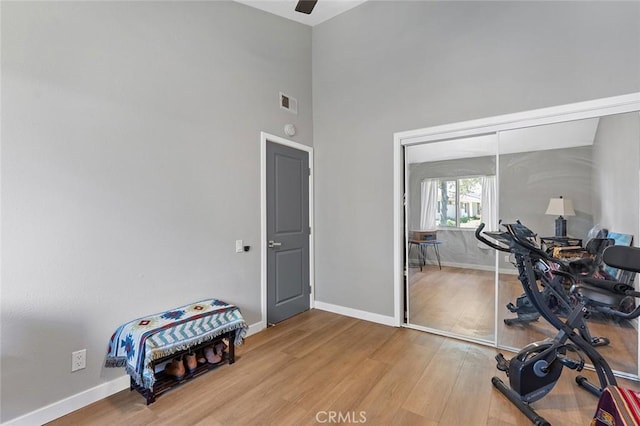 3660 Vista Campana N Unit 11, Oceanside, CA 92057 - workout area with wood finished floors, baseboards, a high ceiling, and ceiling fan