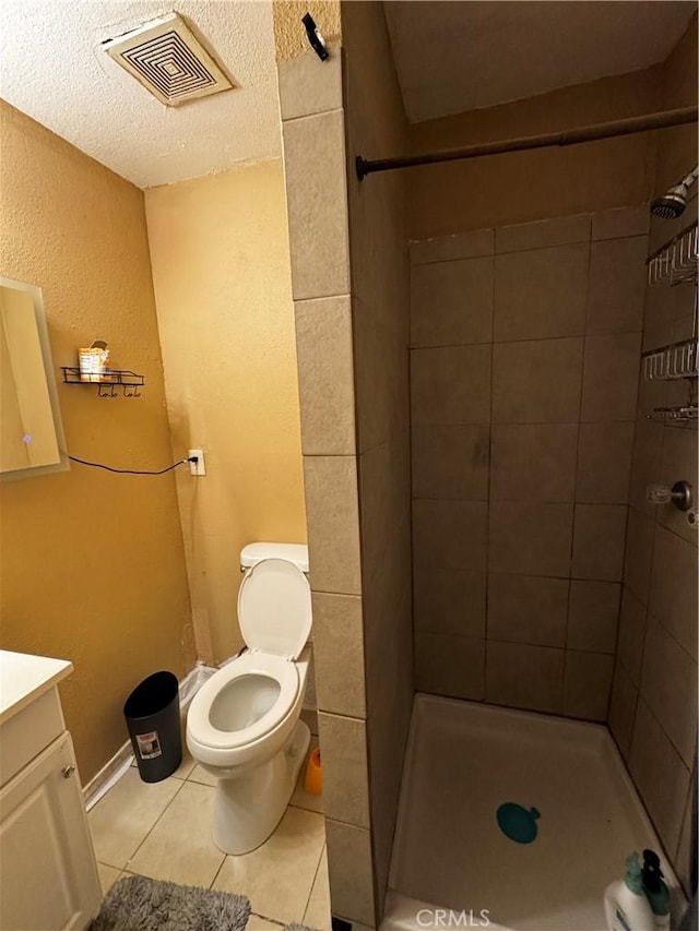 12145 Wanda St, El Monte, CA 91732 - bathroom featuring vanity, tile patterned floors, a stall shower, toilet, and a textured ceiling