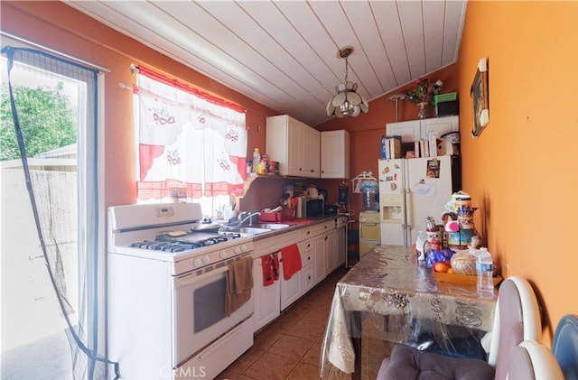 12145 Wanda St, El Monte, CA 91732 - kitchen featuring white appliances, healthy amount of natural light, lofted ceiling, white cabinetry, and wood ceiling