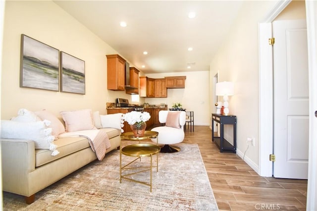 living room with light wood finished floors, recessed lighting, and baseboards