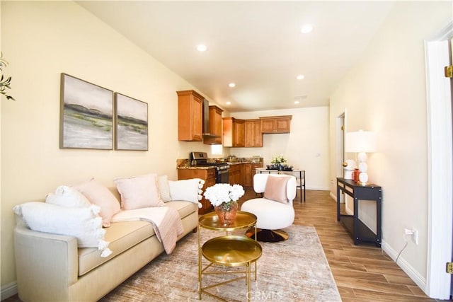 living room with light wood-style floors, recessed lighting, and baseboards