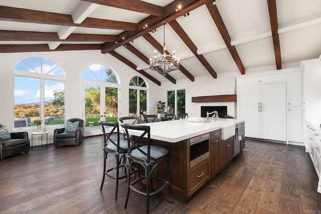 8374 St Andrews Rd, Rancho Santa Fe, CA 92067 - kitchen with open floor plan, a chandelier, a breakfast bar area, light countertops, and an island with sink