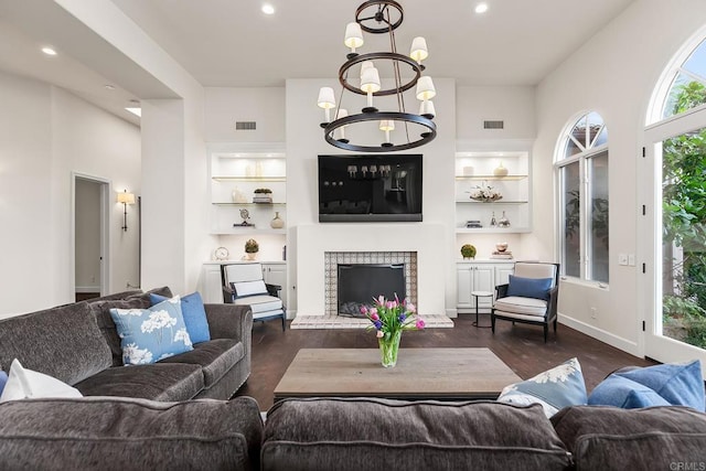 8374 St Andrews Rd, Rancho Santa Fe, CA 92067 - living room with dark wood-style floors, built in features, recessed lighting, a fireplace, and a chandelier